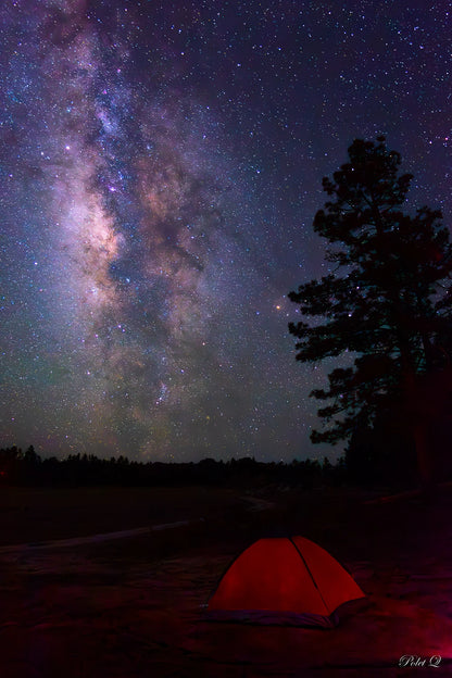 Red tent under a starry night sky with the view of the Milky Way galaxy.